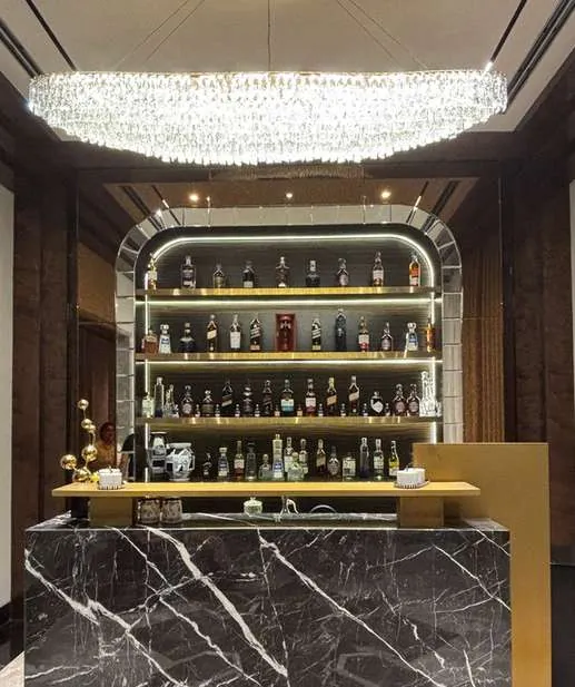 Bespoke bar unit with marble counter and lit shelving