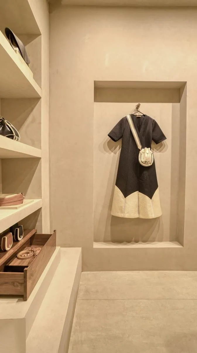 Arched plaster niche displaying apparel at AM PM boutique