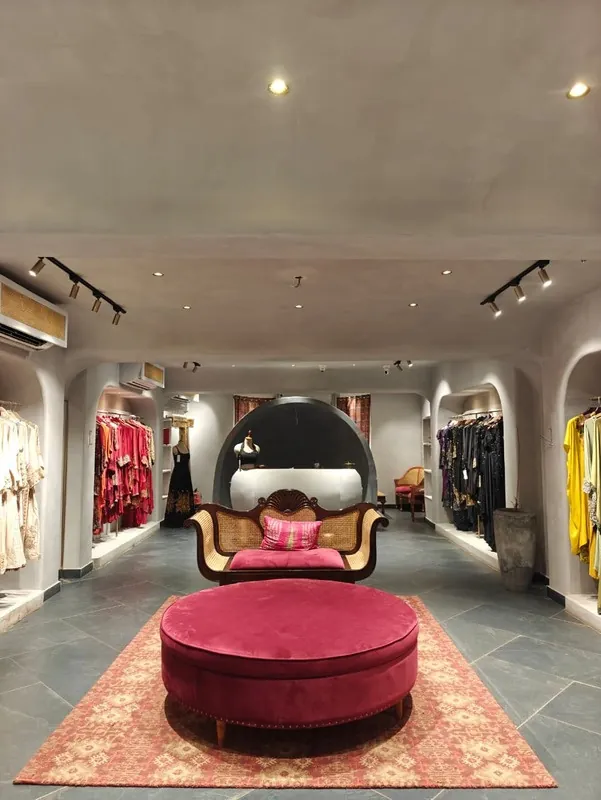 Red velvet ottoman on a rug in the ARRV boutique salon
