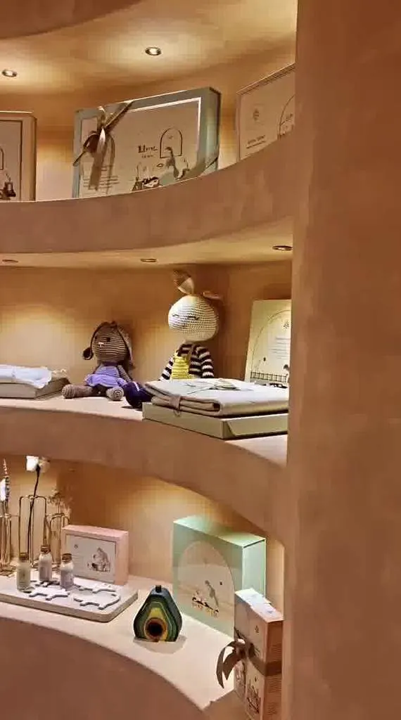 Curved terracotta plaster display niches at the Baby Forest store