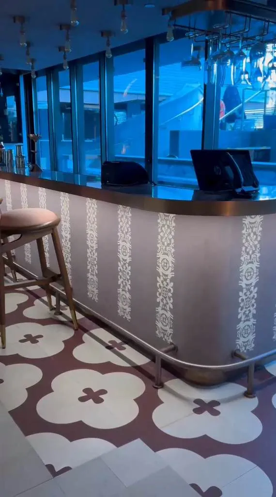 Textured bar counter and patterned cement tile floor at Novotel Goa