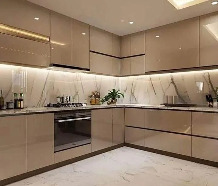 L-shaped high-gloss beige modular kitchen with marble backsplash