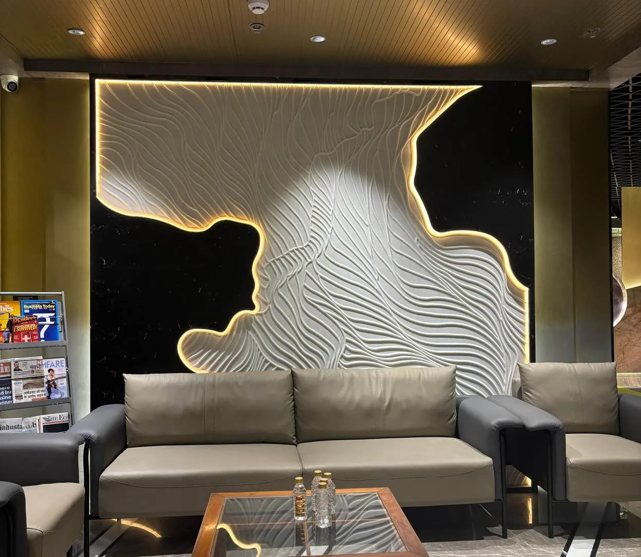 Sculpted 3D wave relief feature wall with backlit black surround